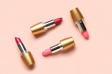 Obraz premium Different bright lipsticks on pink background