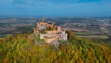 Aerial drone view of medieval Hohenzollern castle on top of hill in autumn, Baden-Wurttemberg,...