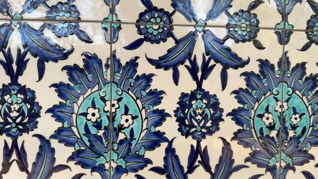 Traditional blue Turkish tiles found in one of the Imperial Ottoman Mosques interior walls in Istanbul Turkey. Abstract rotating background of painted ceramic tiles in blue and white