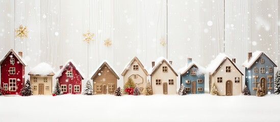 Vintage white wooden background with bell adorned little houses for Christmas