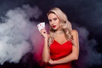 Photo of glossy fancy lady wear sexy dress rising two red aces playing cards isolated black color...