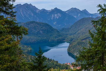Fototapeta na wymiar Turquoise lake in mountains Bavarian Alps on foggy morning. Ski resort in auttumn.