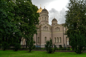 Fototapeta na wymiar Architectural landscape with the Riga Nativity of Christ Orthodox Cathedral on a cloudy summer day. A view of this majestic church building at Esplanade in central Riga.