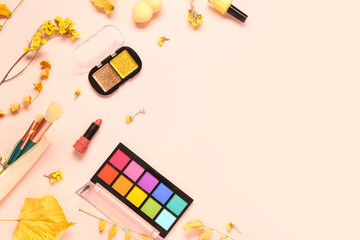 Composition with cosmetic products, yellow autumn leaves and flowers on light background