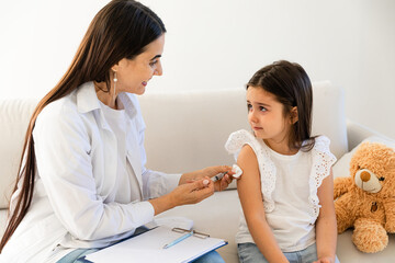 Doctor giving injection to little girl in hospital, closeup. Immunization concept. child is scared and crying