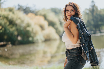 Girl enjoying a sunny day in a park and relaxing in nature. Copy space.