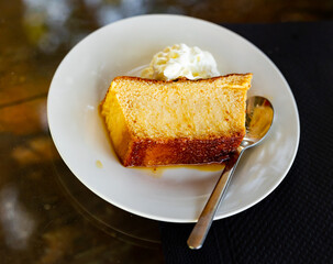 Indulge in creamy, delectable pudding served elegantly on pristine porcelain plate.