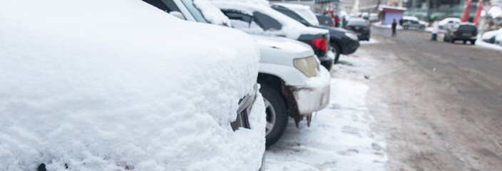 Parked cars covered with snow