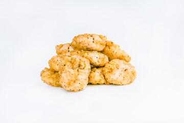 Breaded Chicken Inner Fillet on a White Background,Chicken Breaded Raw Meat.Chicken Breaded Fillet.Fast food. Fast cooking. Breaded chicken nuggets. Homemade food at home.