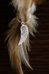 Photo of a silver earring on a textured background.