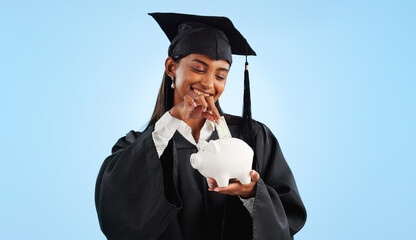 Woman, graduation and piggy bank in studio, saving and cash for investing, future or goals by blue background. Student girl, banking and money with thinking, decision and choice for financial plan