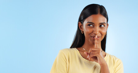 Secret, gossip and woman with finger on lips, smile and announcement on a blue background. Person,...