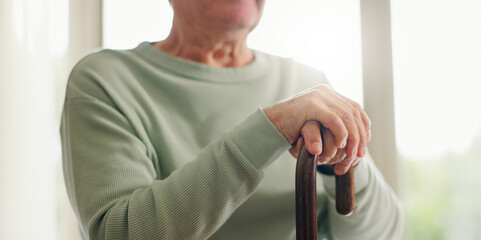 Hands, senior and walking stick, person with a disability and closeup with wellness. Elderly care,...