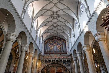 Fototapeta premium Ceiling and rear part with organ in a light Romanesque three-nave columned basilica. Minster (Münster Unserer Lieben Frau Konstanz), Lake Constance (Bodensee), Baden-Württemberg, Germany.