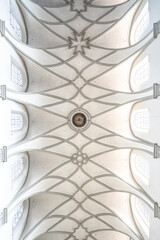 Bright white ceiling of a brightly lit Romanesque three-nave columned basilica, photographed from below. Minster (Münster Unserer Lieben Frau Konstanz), Lake Constance, Baden-Württemberg, Germany.