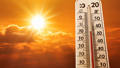 hot summer or heat wave background glowing sun on orange sky with thermometer