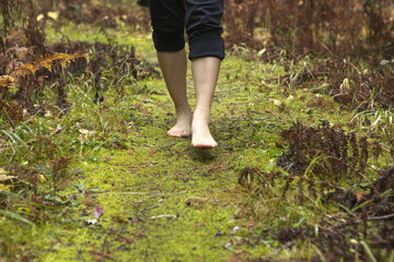 Strolling barefooted on a nature trail.