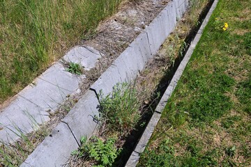 Trough , drainage of sewage outflow overgrown in grass