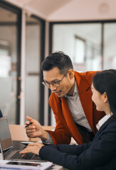 Four asian people in an office, working together on laptops, discussing tasks. annual gathering where attendees share and discuss opinions, presentation teamwork group meeting laptop in boardroom