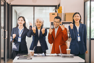 Four asian people in an office, working together on laptops, discussing tasks. annual gathering where attendees share and discuss opinions, presentation teamwork group meeting laptop in boardroom