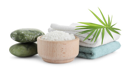 Fototapeta na wymiar Bowl of sea salt, towels, massage stones and palm leaf isolated on white. Spa treatment