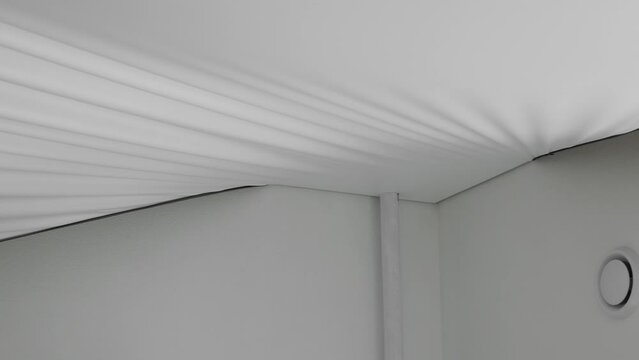 Installing and maintenance stretch ceiling in new flat. Construction of apartment