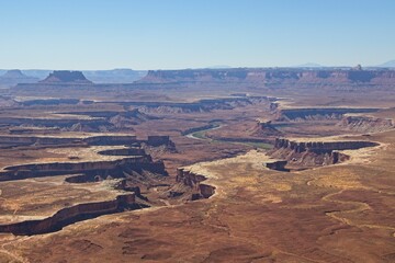 Fototapeta na wymiar Canyonlands National Park offers breathtaking views of eroded canyons, rocky mesas and strange buttes in the area where the Green River and Colorado River meet in their canyons far below