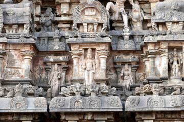 Ancient Hindu temple tower with stone carvings of God sculpture. Tall tower with idols at Airavatesvara Temple, Darasuram, Kumbakonam, Tamilnadu.