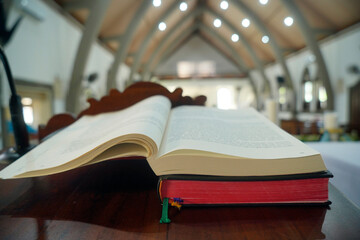 Fototapeta premium Bible books on church background. Open page of bible book. Christianity concept.