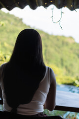 Young Woman drinking coffee with the mountains in the background