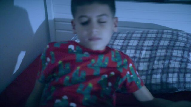 a sleepwalking child gets up from his bed while sleeping in his room at night