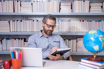 school education. Teacher in school classroom. education with hispanic teacher. millenial teacher educate. Man teaching lesson in class. teachers day. back to school. teacher at bookstore. make notes