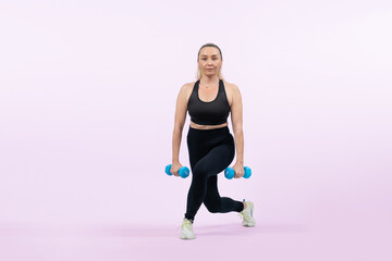 Fototapeta na wymiar Full body length shot active and sporty senior woman lifting dumbbell during weight training workout on isolated background. Healthy active physique and body care lifestyle for pensioner. Clout