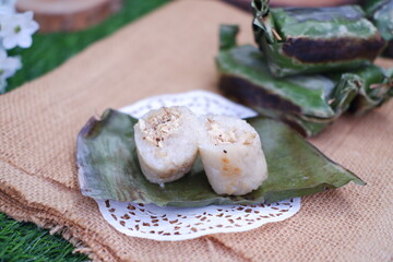 Lemper Bakar. Lemper is a traditional Indonesian snack made of glutinous rice and filled with chicken meat and wrapped in banana leaves. Selective focus