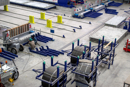 Two workers were installing steel strand in prestressed systems.
