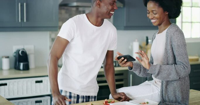 Man, woman and picture of food in kitchen for breakfast, fruit or strawberry for social media, web or app. African people, happy couple and smile while swipe on mobile screen for post on internet