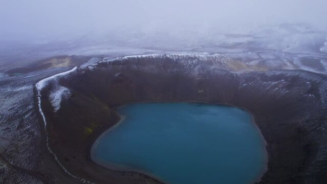 Huge blue geothermal crater lake of Viti in snowy landscape, Iceland. Aerial view