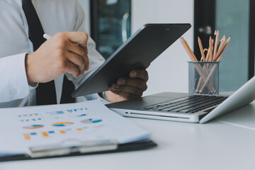 Close up of Business team analyzing income charts and graphs with modern laptop computer. Business analysis and strategy concept.