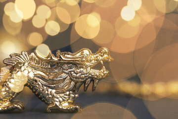 Golden dragon symbol of the year 2024 on a dark background