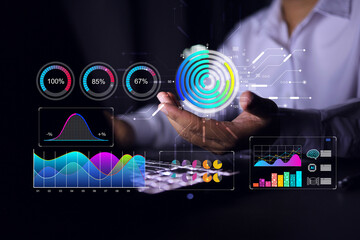 Businessman hand holding data in donut graph to summarize the results in various format on analytic dashboard from laptop screen interface. Data visualization concept.
