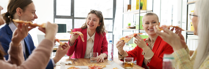 Happy company staff enjoys fastfood at pizza party in office