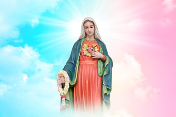 Fototapeta premium Statue of Our lady of grace virgin Mary with beautiful Sky Pastel with abstract colored background and wallpaper in sweet color. at Thailand.