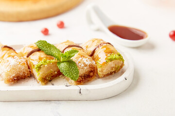 Close up of baklava - traditional turkish dessert with honey and mint. Natural sweets close up