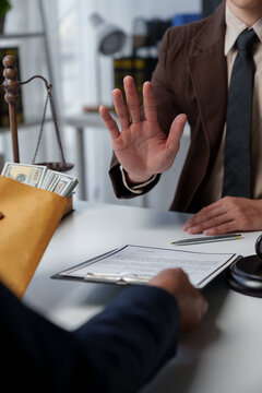 Businessman or accountant is rejecting and resisting partner bribery deals in joint financial settlement, illegal anti-bribery ideas. In work