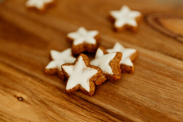 Gingerbread cookies in the shape of stars on a wooden brown natural table. Christmas background. Winter card. Delicious pastries close-up