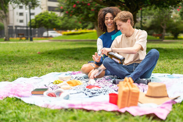 Couple enjoying picnic together in a park
