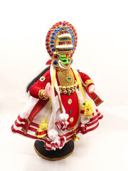 toy size miniature statue doll of kathakali dancer, a cultural art of kerala in india isolated in a white background 