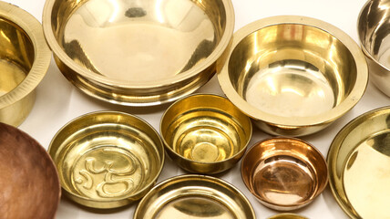 closeup of old antique gold bowl plates used in a luxury kitchen isolated in a white background