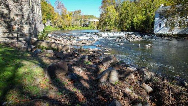 low drone flyover stream rapids brandywine river in autumn in delaware
