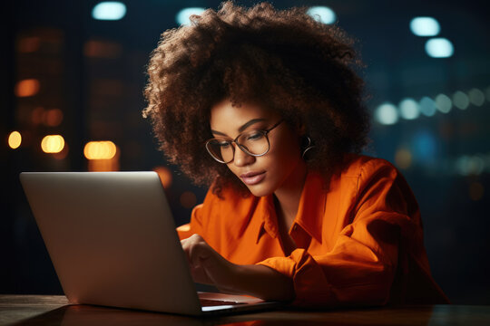 Woman in orange shirt using laptop. This image can be used to depict technology, remote work, or online communication.